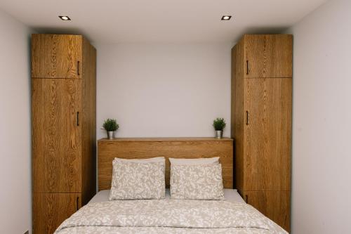 a bedroom with a bed with wooden headboards at Ste's house at Macedonia Airport in Thessaloniki