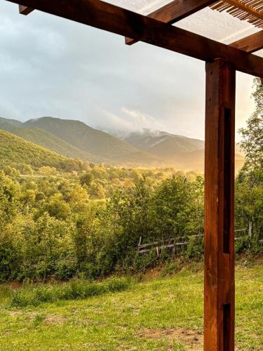a view of the mountains from the porch of a cabin at Willow Tiny House - ElysianFields in Sadu
