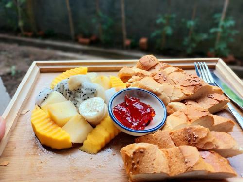 un plato de comida con fruta y un tazón de salsa en Discover Kratie Homesetay, en Kratié