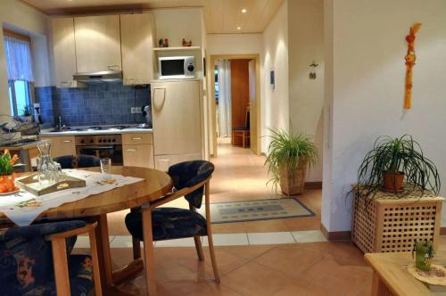 a kitchen and dining room with a table and chairs at Fischers Ferienhaus in Alken