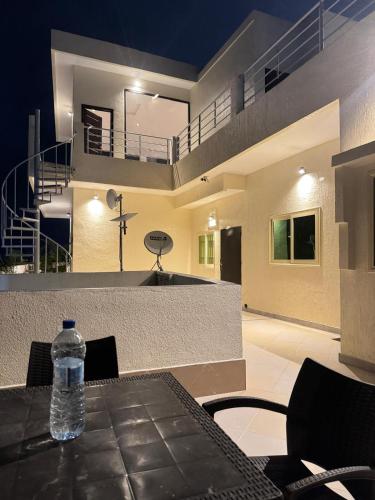 a bottle of water sitting on top of a table at RESIDENCE MH SERVICES Cotonou in Cotonou