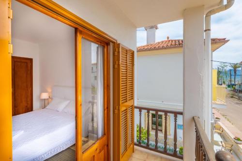 a bedroom with a bed and a balcony at Ca Na Clara - Villa Pascual in Port de Pollensa