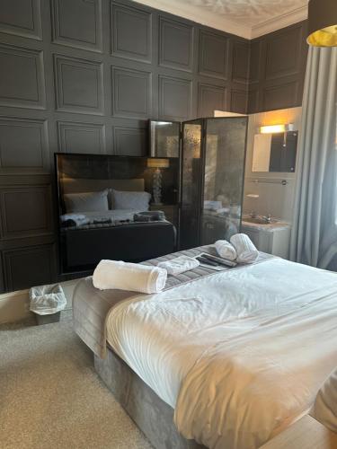 a bedroom with a large bed in a room at The Q Hotel in Shanklin