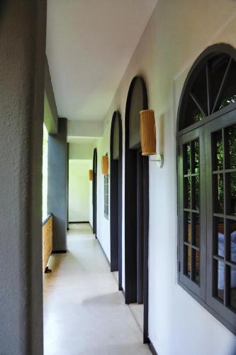a hallway of a house with doors and windows at Xueershanfang · Shanhaijing in Sanya
