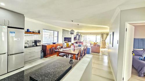 a kitchen and living room with a table in it at Amore in West Point