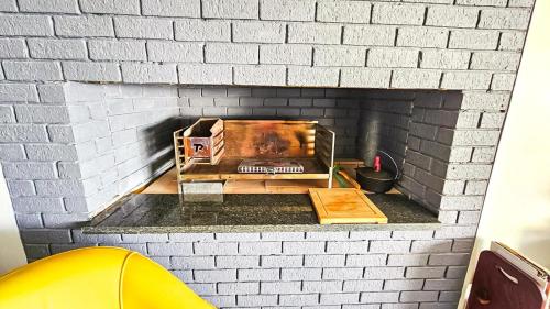 a brick fireplace with a table and a box at Amore in West Point