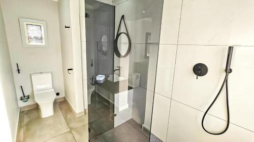a bathroom with a shower and a toilet at Amore in West Point