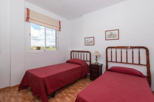Un dormitorio con dos camas y una ventana. en Casa Salinas, en Villanueva de Tapia