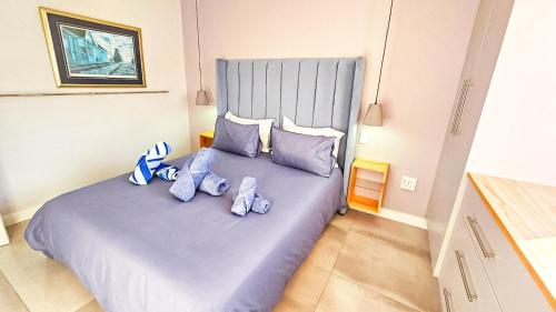 a bedroom with a bed with blue teddy bears on it at Amore in West Point