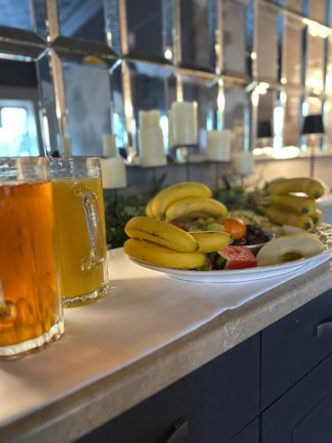 a plate of fruit on a counter with a drink at The Q Hotel in Shanklin