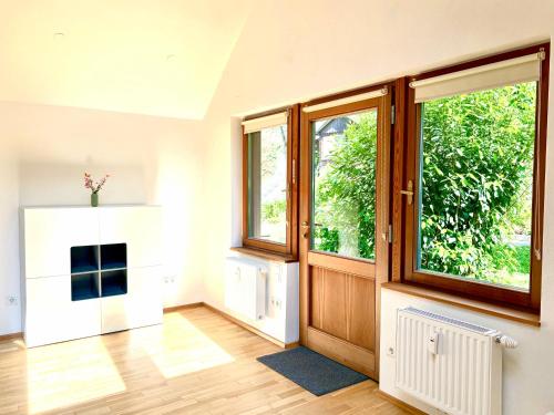 a living room with wooden floors and windows at Ferienwohnung Sterngasse in Melk