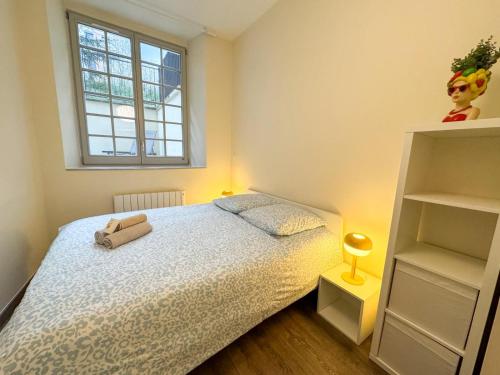 a small bedroom with a bed and a window at Lyon funky flat piscine et parking in Tassin-la-Demi-Lune