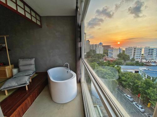 a bathroom with a bath tub on a balcony at Xueershanfang · Shanhaijing in Sanya