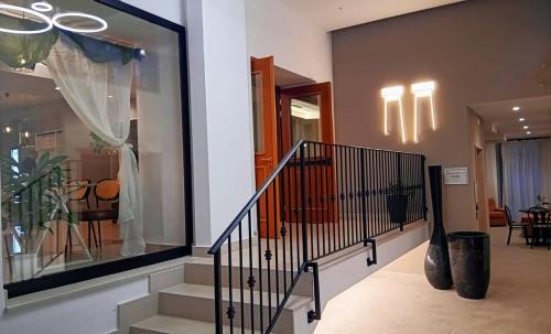 a staircase in a house with a window and a stair case at Hotel Colonne in San Giovanni Rotondo