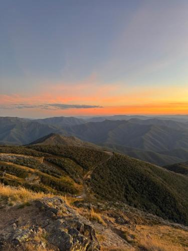 a view from the top of a mountain at sunset at Luxury Alpine Stay with Epic Views at Mt Buller foothills in Merrijig