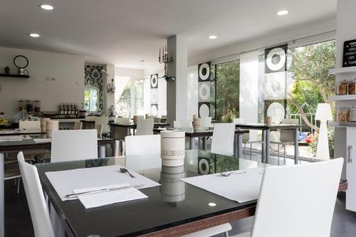 a dining room with a table and white chairs at Villa Liliana in Cervia