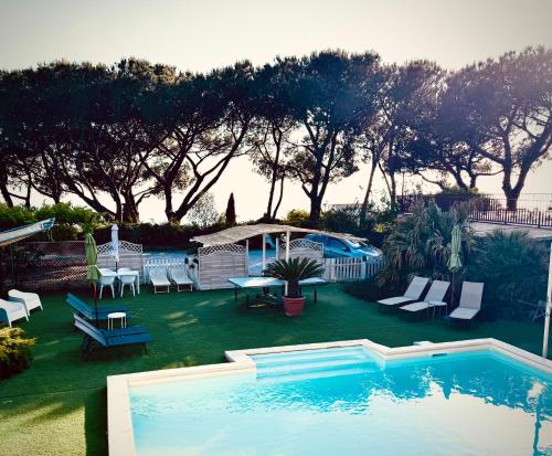 a swimming pool in a yard with chairs and a table at B&B Iolì Vesuvio in Ercolano