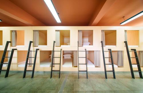 a row of ladders in a room with bunk beds at Tianmen Mountain Panorama & Cultural Art Exchange Hostel in Zhangjiajie