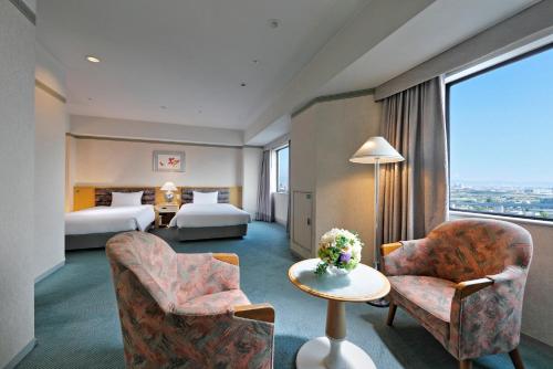 Postel nebo postele na pokoji v ubytování Miyako Hotel Amagasaki