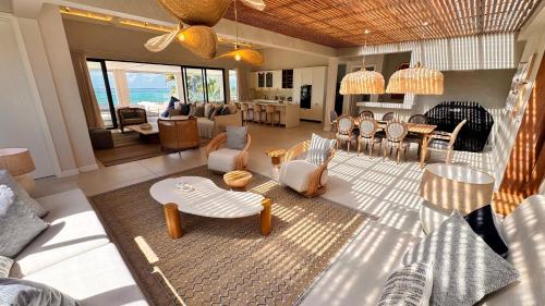 a living room with chairs and tables at Le Dalblair by Horizon Holidays in Pointe d'Esny