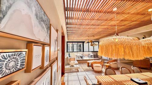 a living room with a chandelier and a table and chairs at Le Dalblair by Horizon Holidays in Pointe d'Esny