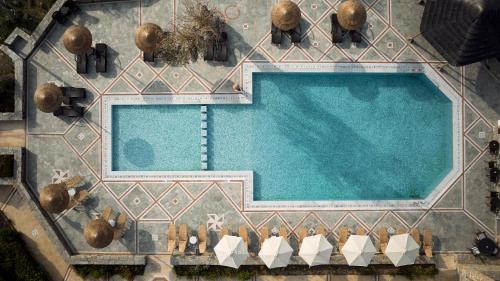 an overhead view of a swimming pool with lounge chairs at Porto Kea Suites by Sandglass in Korissia