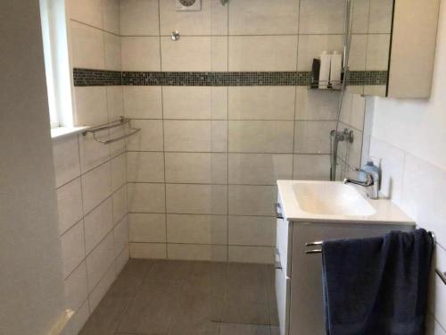 a bathroom with a sink and a shower at Family House Near Beach With Garden in Sarup