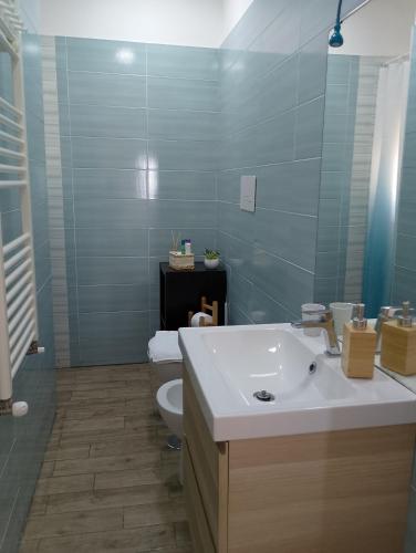 a bathroom with a white sink and a toilet at Almarisa - appartamento vista mare in Salerno
