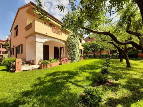 a house with a green yard in front of it at Apartments Mirella in Novigrad Istria