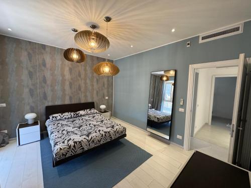 a bedroom with a bed and a mirror and lights at Casa vacanza Tolda in Lido di Ostia