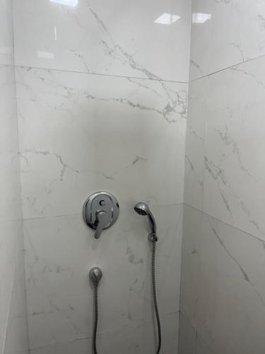 a shower with a shower head in a bathroom at Villa moderne avec piscine, front de mer in Casablanca