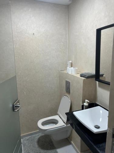 a bathroom with a toilet and a sink at Villa moderne avec piscine, front de mer in Casablanca