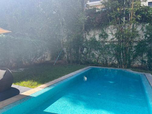 a small blue swimming pool in a yard at Villa moderne avec piscine, front de mer in Casablanca