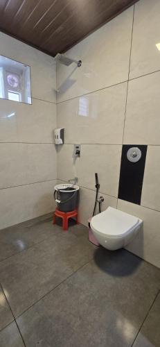 a bathroom with a toilet and a sink at Fortune Retreats in Ooty
