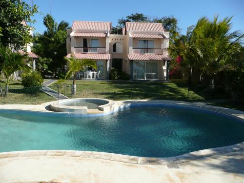 a large swimming pool in front of a house at Villas Banyan in Grand Gaube
