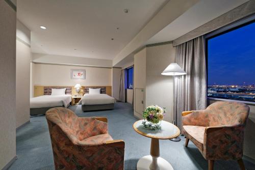 Postel nebo postele na pokoji v ubytování Miyako Hotel Amagasaki