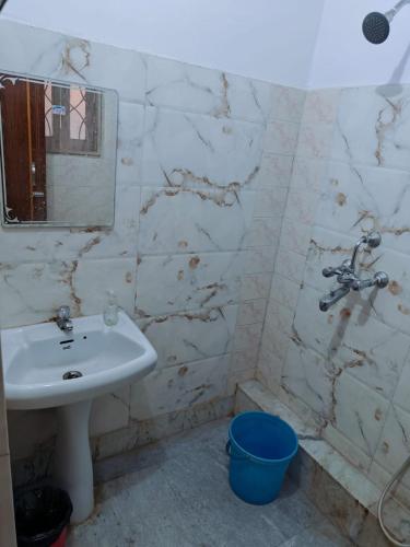 a bathroom with a sink and a mirror at Sidds Hospitality Inn in kolkata