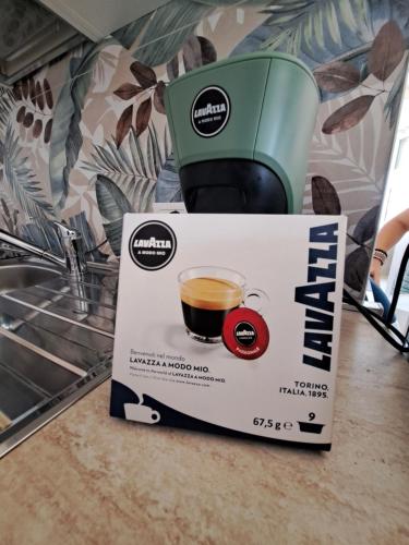 a coffee box with a cup of coffee at Casa HAPPINESS vista mare, 50m dal mare in Marotta