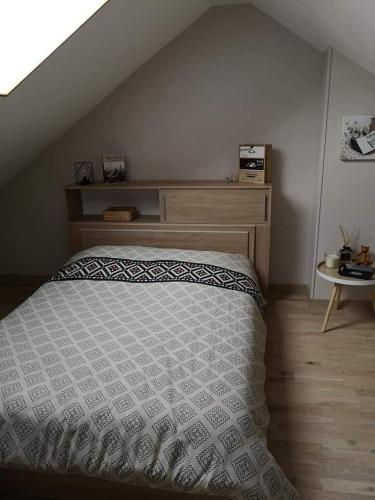 une chambre avec un lit avec une tête de lit en bois dans l'établissement House 10 minutes' walk to 24h, à La Celle-sous-Gouzon