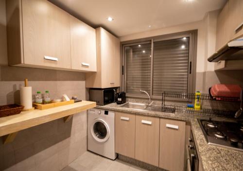 a kitchen with a sink and a washing machine at R101-6- Lovely and Spatious apartments in Belvedere near High Speed Train Station in Casablanca