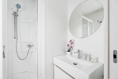 a white bathroom with a sink and a mirror at Club del Sole Vigna sul Mar Family Collection in Lido di Pomposa