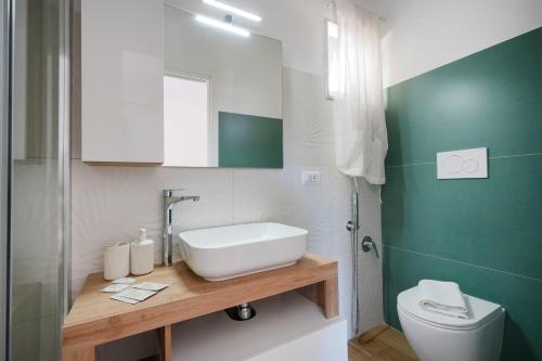 a bathroom with a sink and a toilet at Casa - Merlino in Santo Spirito