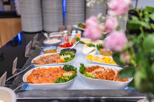 a buffet with many dishes of food on a table at Clarion Hotel The Edge in Tromsø