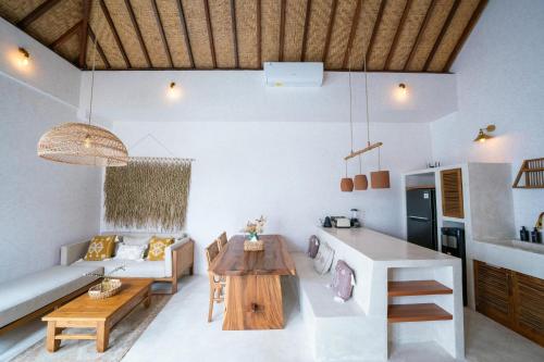 a living room with a couch and a table at Villa Taman & Villa Serai Kedungu in Tanah Lot