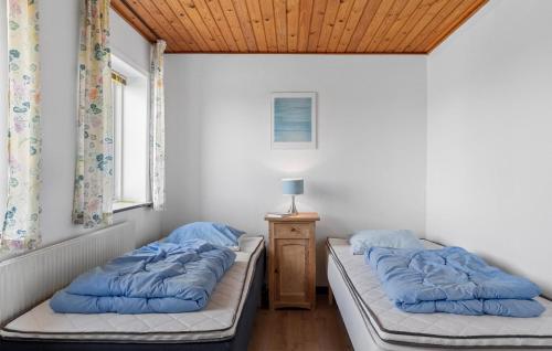 a room with two beds and a table with a lamp at Gorgeous Home In Sydals With Wifi in Trænge