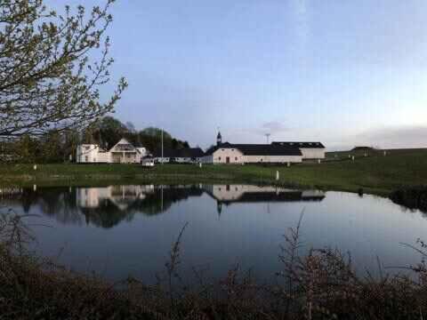 a view of a lake with houses in the background at Relax In Scenic Surroundings in Østbirk