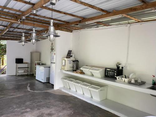 a large room with white walls and ceilings with lights at Canopy Villa Glamping Park in Kampong Sum Sum
