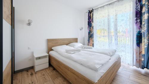 Postel nebo postele na pokoji v ubytování Sun Apartments, Sun & Snow