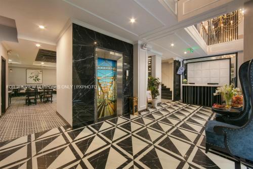 a lobby with a black and white tiled floor at Paradise Grand Center Hanoi Hotel in Hanoi