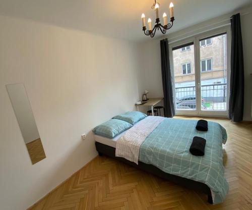 a bedroom with a bed and a large window at Fantastic-Inn Warszawa - Chmielna in Warsaw